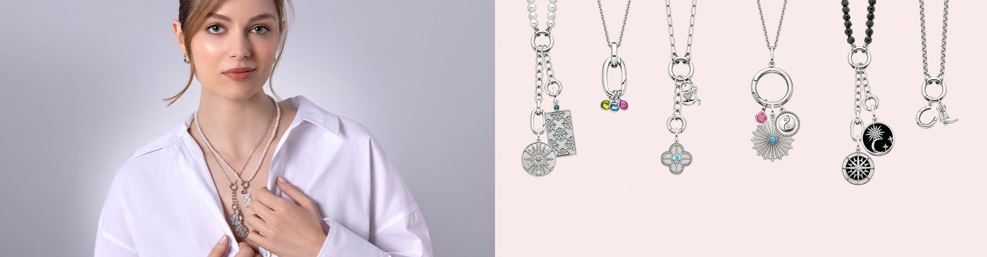 A woman wearing a white shirt models a silver charm necklace 