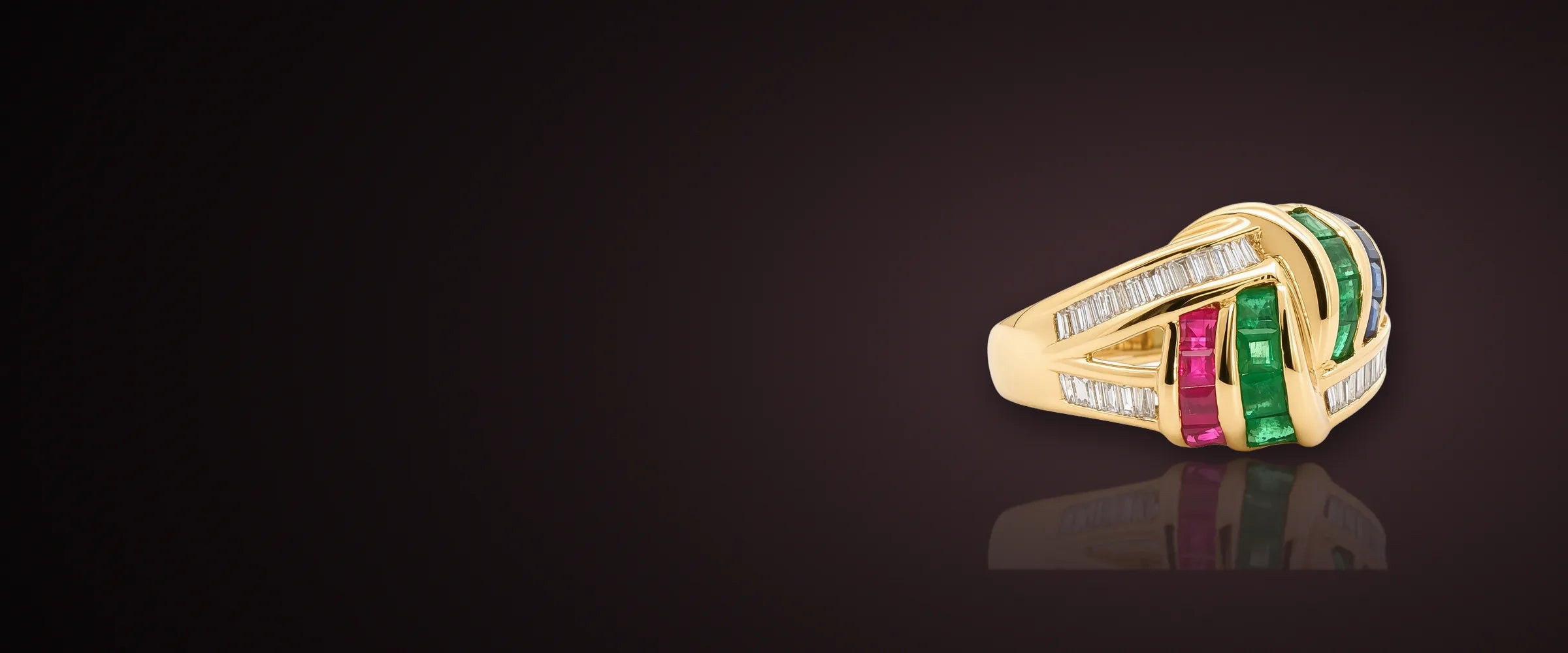 Estate yellow gold ring with channel-set rubies, emeralds and baguette diamonds
