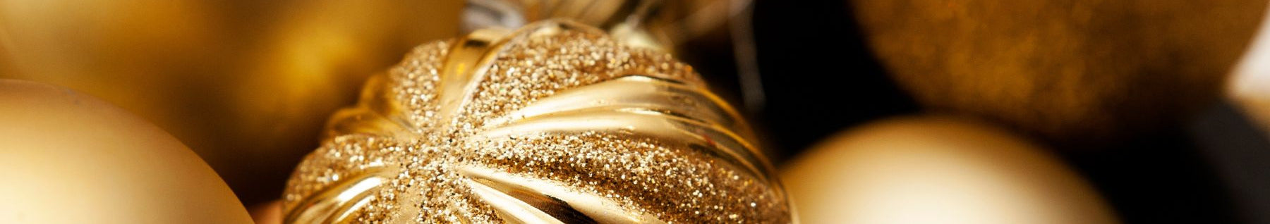 Close-up of gold Christmas ornaments with a blurred background