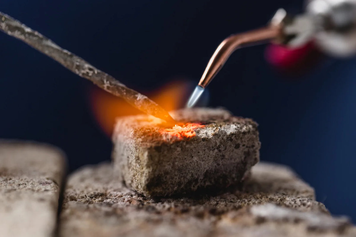 Close-up picture and a torch and jeweler melting gold.